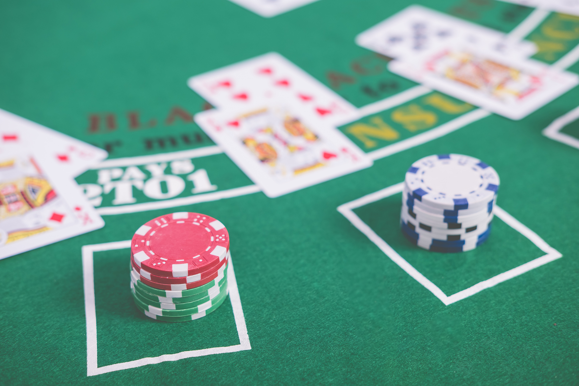 Close-up of a blackjack table with playing cards and stacks of poker chips, showcasing a winning hand. This image relates to an article discussing the best online casinos for blackjack, highlighting the excitement and strategic elements of the game.